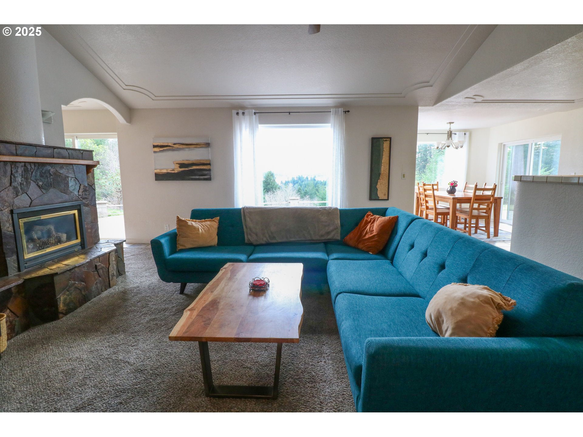 94088 Kirkendall Lane North Bend, OR 97459 - Photo 20 of 46 a living room with furniture and a fireplace