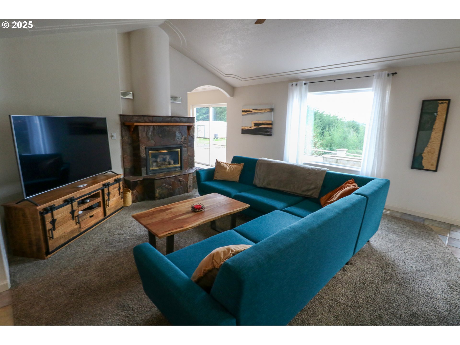 94088 Kirkendall Lane North Bend, OR 97459 - Photo 22 of 46 a living room with furniture and a flat screen tv