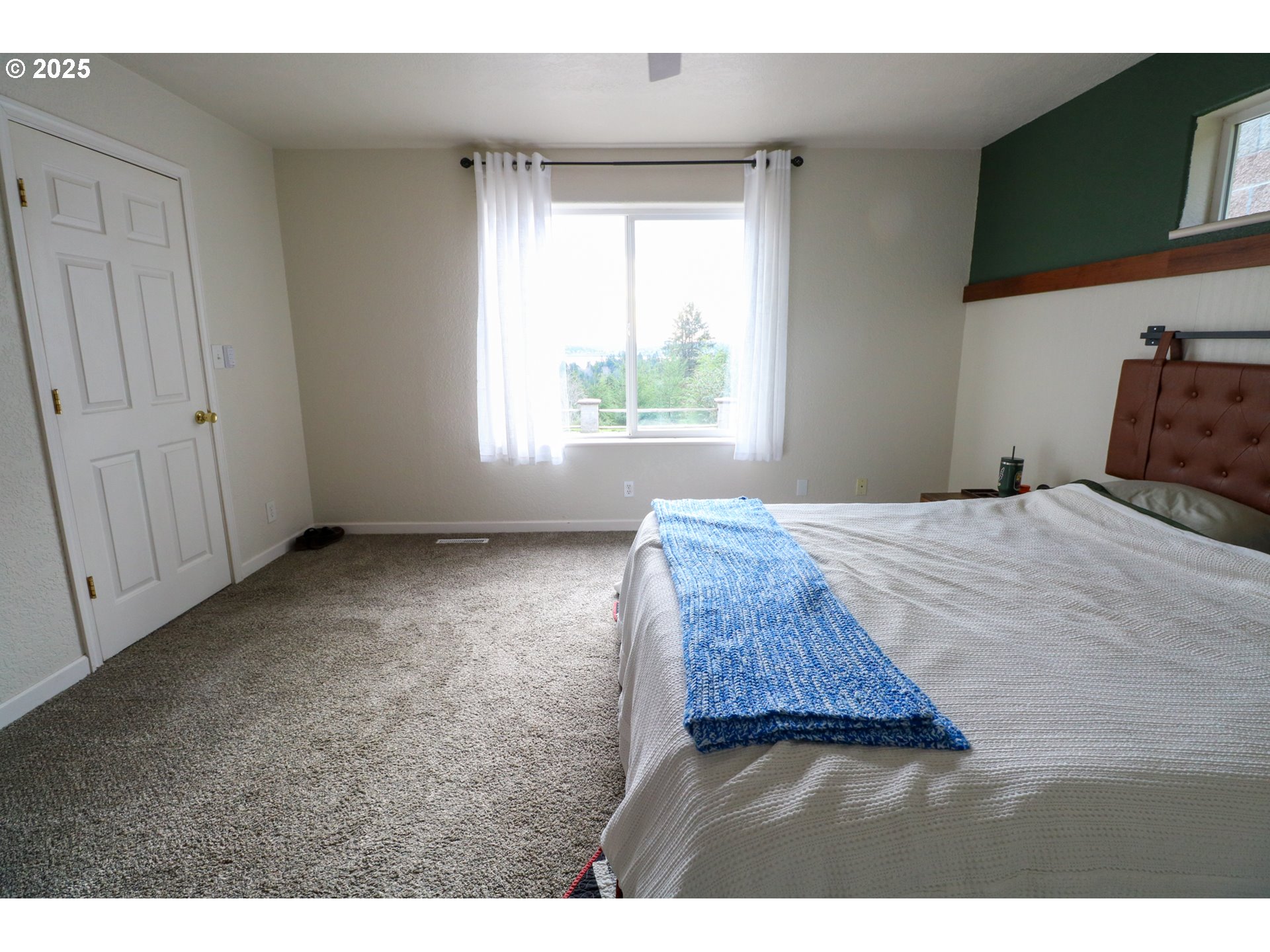 94088 Kirkendall Lane North Bend, OR 97459 - Photo 24 of 46 a bedroom with a bed and a window