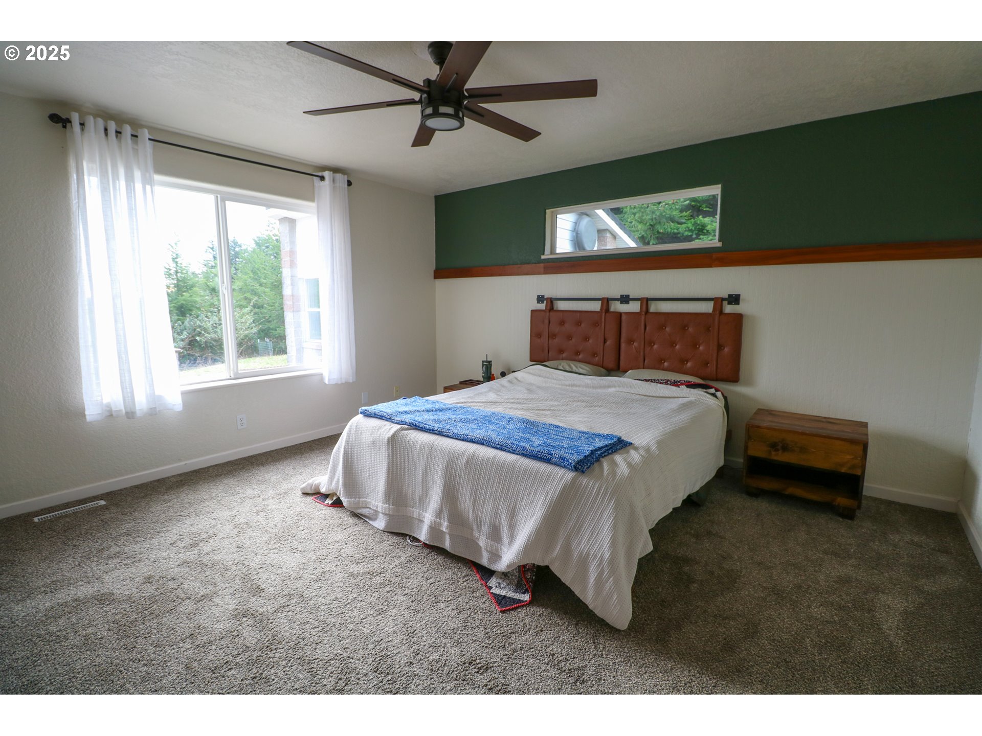 94088 Kirkendall Lane North Bend, OR 97459 - Photo 25 of 46 a bed sitting in a room next to a window