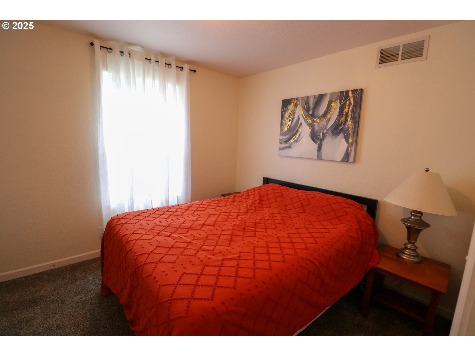 94088 Kirkendall Lane North Bend, OR 97459 - Photo 30 of 46 a bedroom with a bed and a painting on the wall