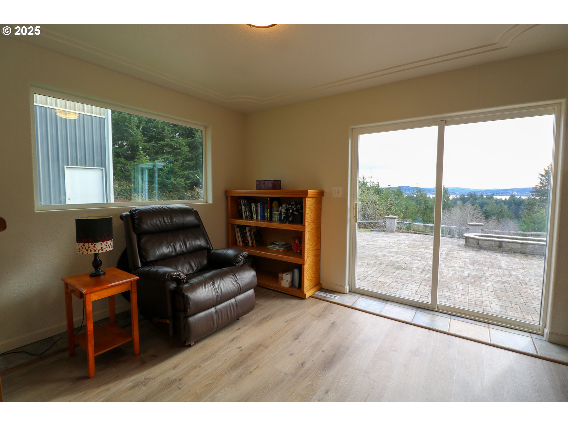 94088 Kirkendall Lane North Bend, OR 97459 - Photo 34 of 46 a living room with furniture and a floor to ceiling window