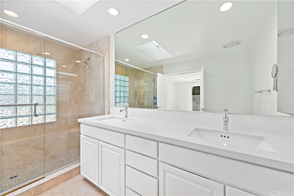 147 Monarch Bay Drive Dana Point, CA 92629 - Photo 11 of 16 a bathroom with a sink and a mirror