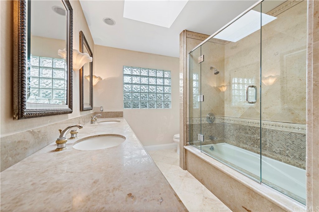 147 Monarch Bay Drive Dana Point, CA 92629 - Photo 16 of 16 a bathroom with a granite countertop tub sink and shower