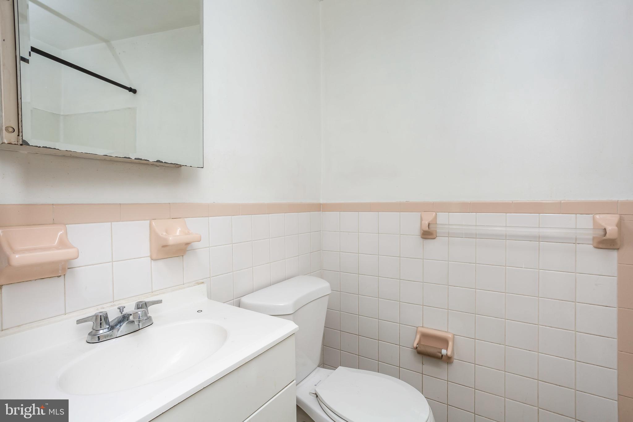 728 Aldworth Road Baltimore, MD 21222 - Photo 11 of 21 a white toilet sitting next to a bathroom sink