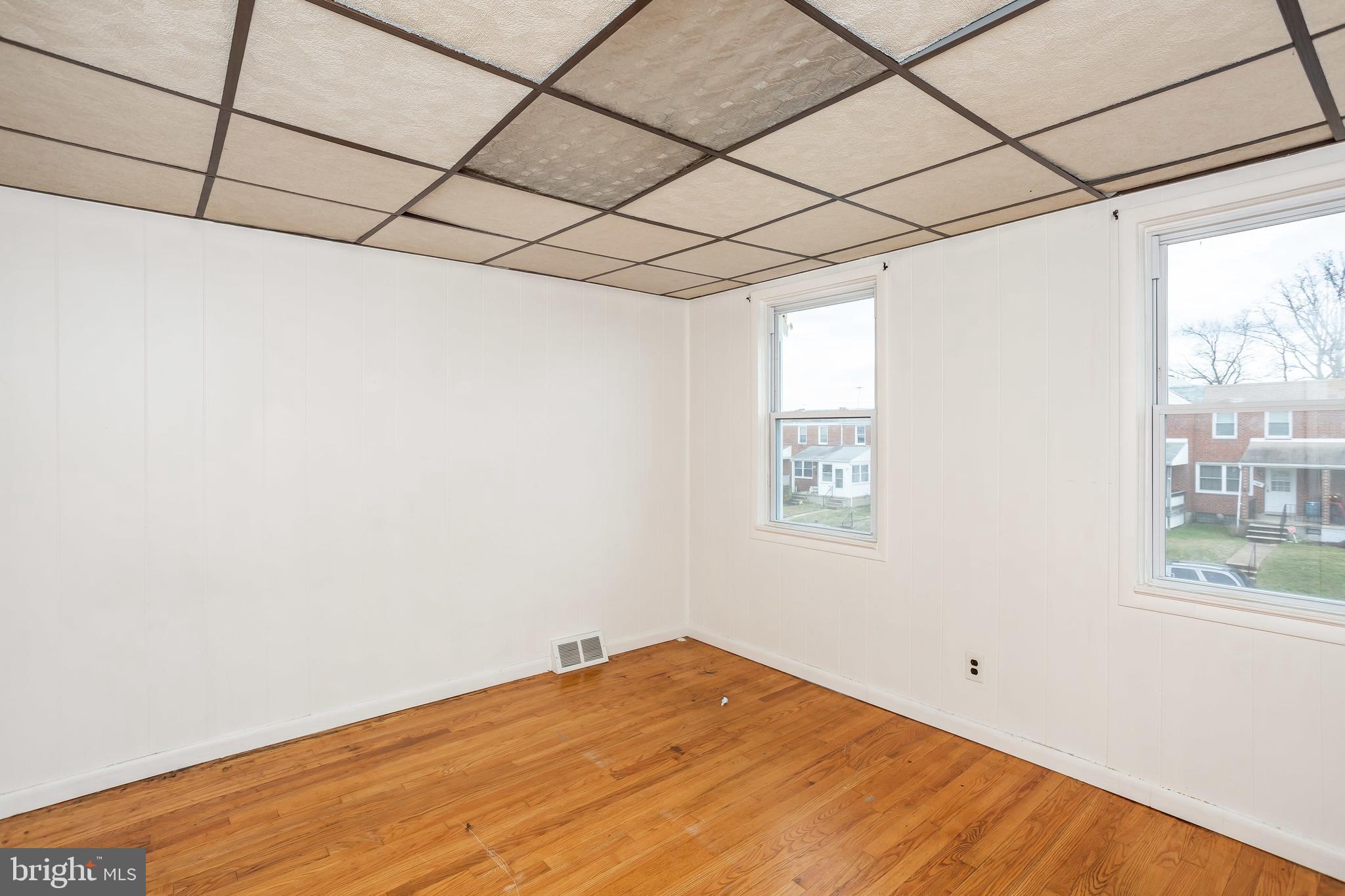 728 Aldworth Road Baltimore, MD 21222 - Photo 13 of 21 a view of empty room with wooden floor and fan