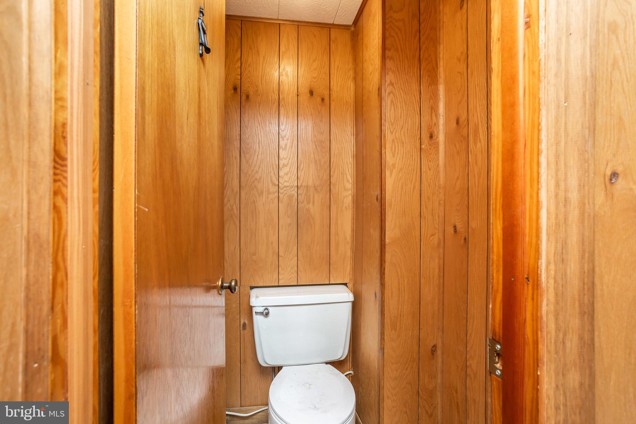 728 Aldworth Road Baltimore, MD 21222 - Photo 17 of 21 a bathroom with a toilet and a shower curtain