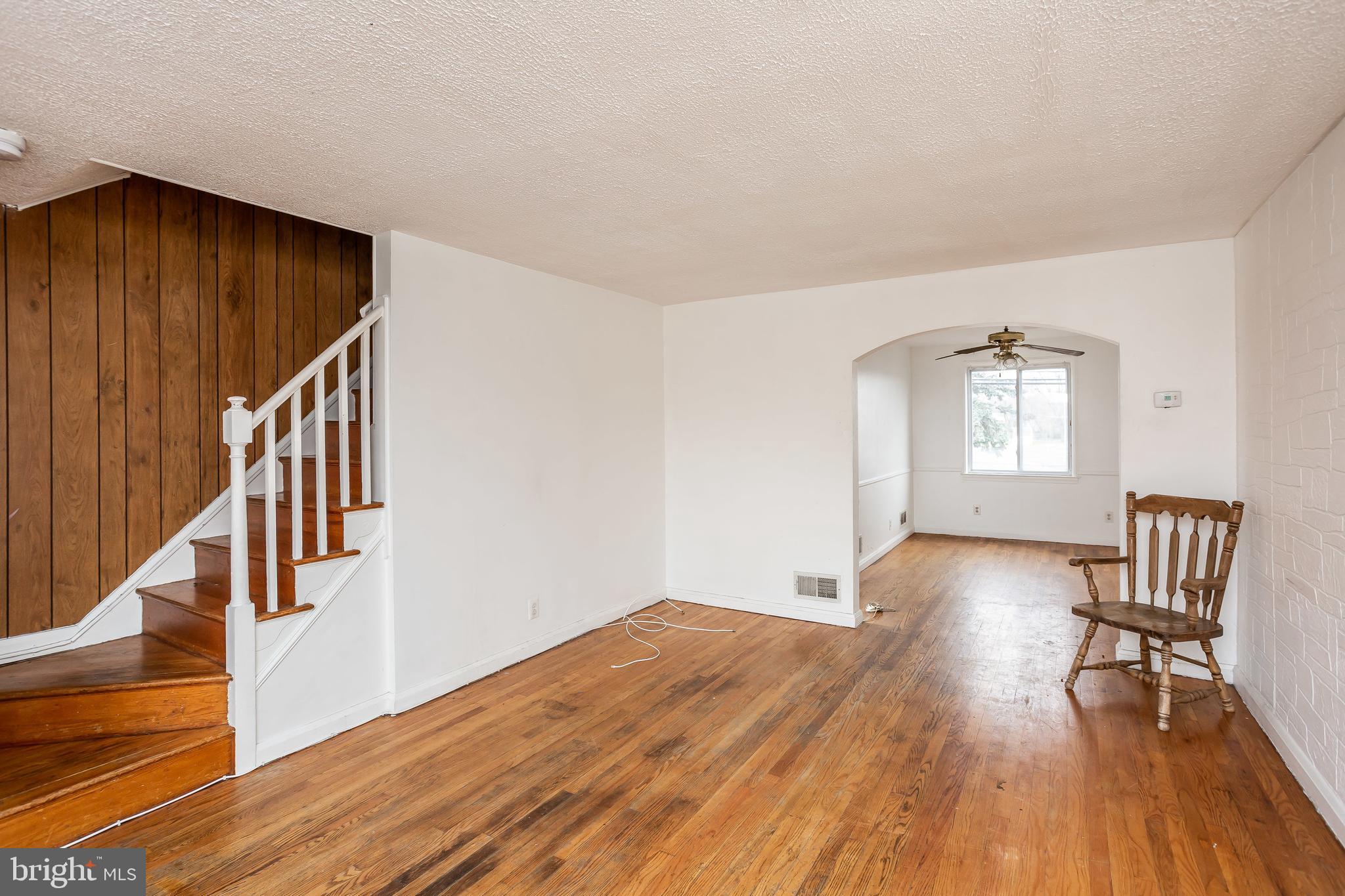 728 Aldworth Road Baltimore, MD 21222 - Photo 3 of 21 a view of empty room with wooden floor and fan
