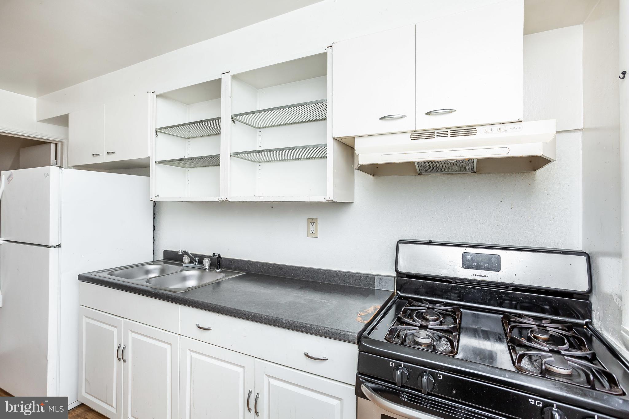 728 Aldworth Road Baltimore, MD 21222 - Photo 7 of 21 a kitchen with granite countertop a stove and a sink