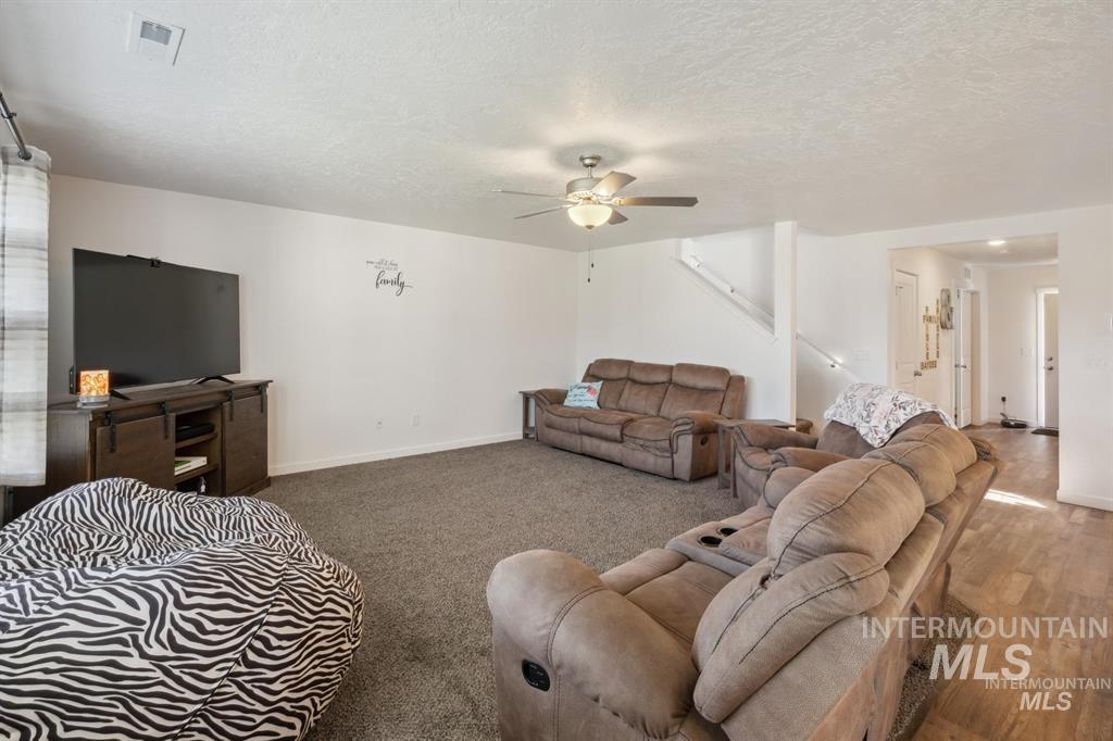 12656 Brun Street Caldwell, ID 83607 - Photo 9 of 39 Living area featuring a textured ceiling and a ceiling fan