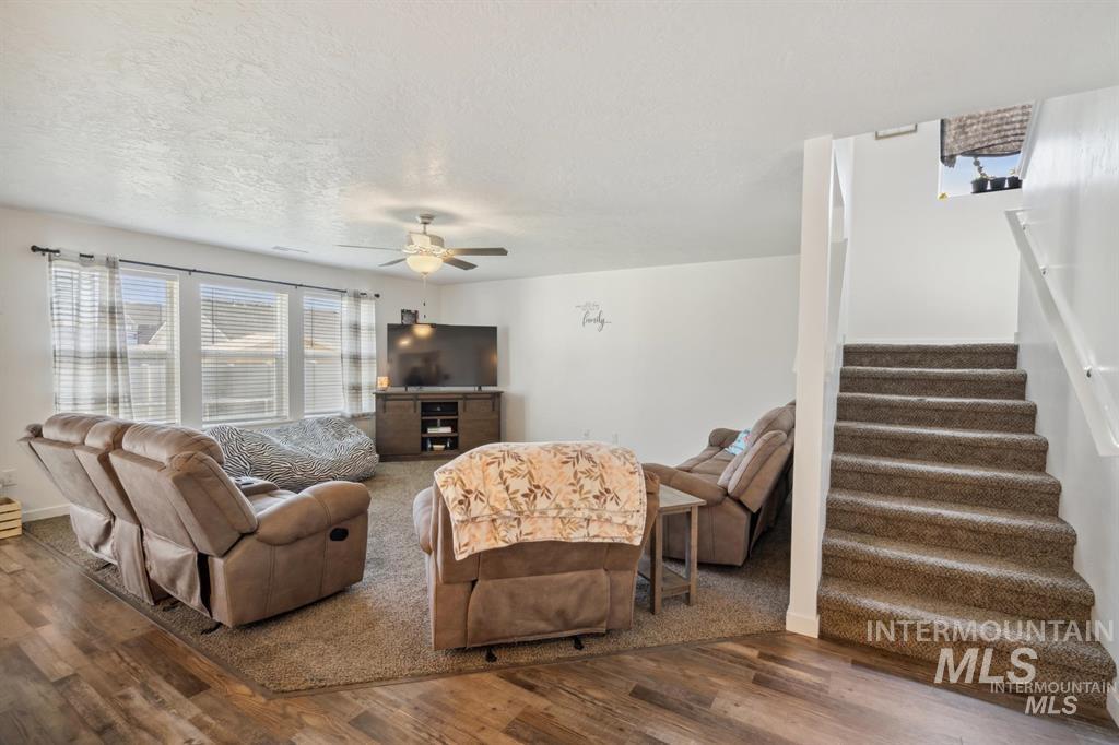 12656 Brun Street Caldwell, ID 83607 - Photo 10 of 39 Living room featuring wood finished floors, ceiling fan, and a textured ceiling