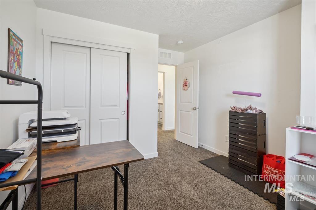12656 Brun Street Caldwell, ID 83607 - Photo 19 of 39 Office area featuring dark carpet and a textured ceiling