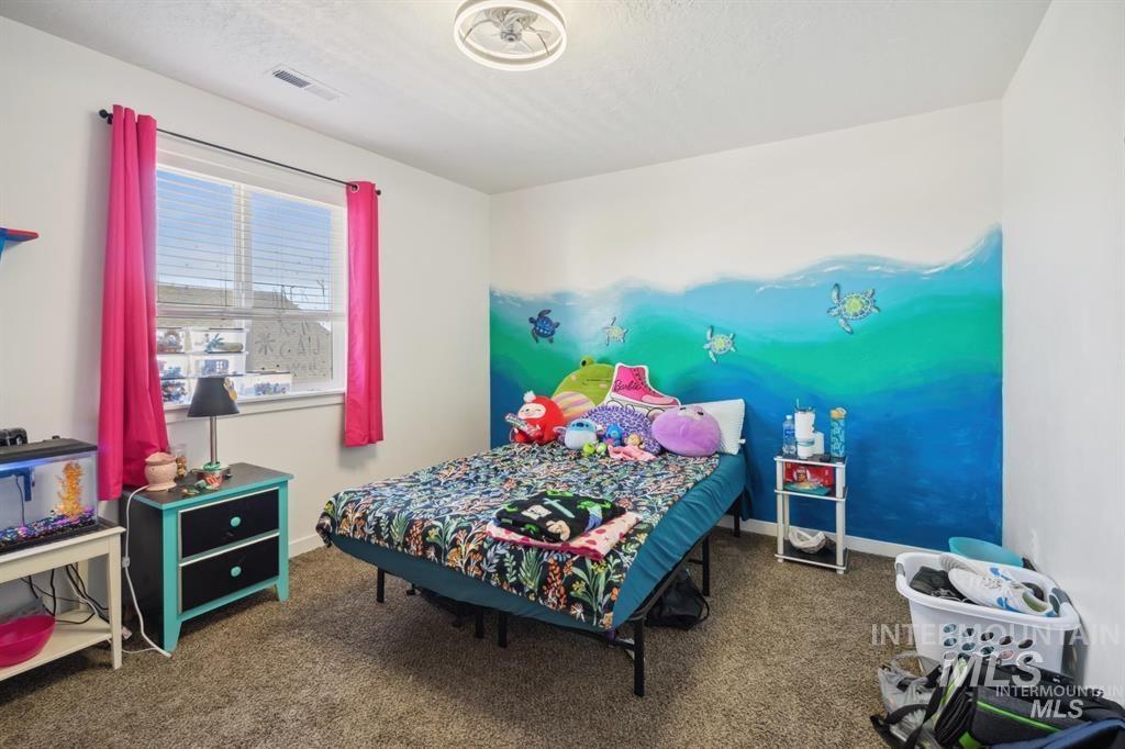12656 Brun Street Caldwell, ID 83607 - Photo 21 of 39 Bedroom featuring dark carpet and baseboards