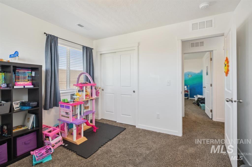 12656 Brun Street Caldwell, ID 83607 - Photo 22 of 39 Playroom featuring dark colored carpet and a textured ceiling