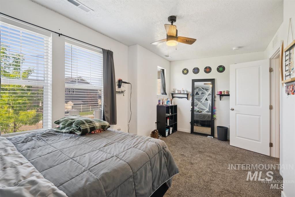 12656 Brun Street Caldwell, ID 83607 - Photo 24 of 39 Carpeted bedroom with ceiling fan and a textured ceiling