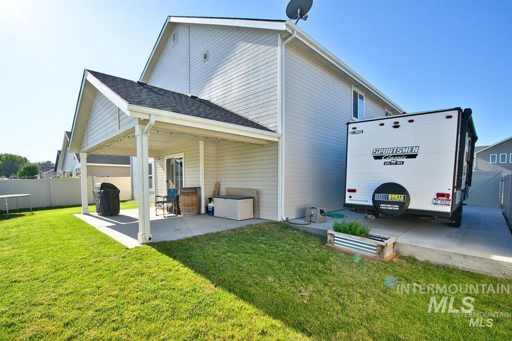 12656 Brun Street Caldwell, ID 83607 - Photo 31 of 39 View of side of property with a patio area and roof with shingles