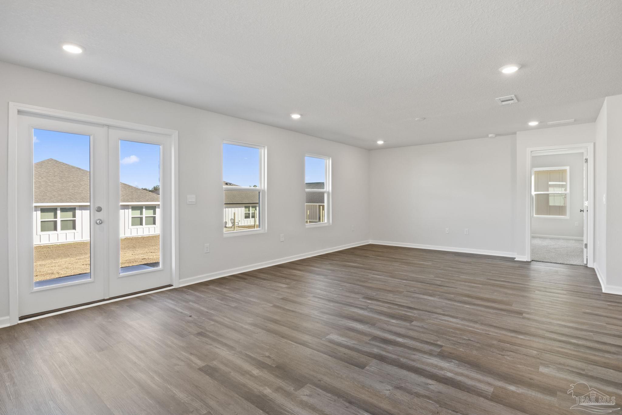 2049 Limpkin Street Cantonment, FL 32533 - Photo 12 of 33 a view of an empty room with window and wooden floor