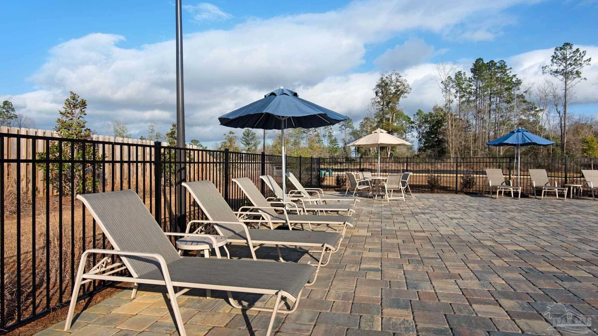 2049 Limpkin Street Cantonment, FL 32533 - Photo 26 of 33 a view of a patio with a table chairs and backyard