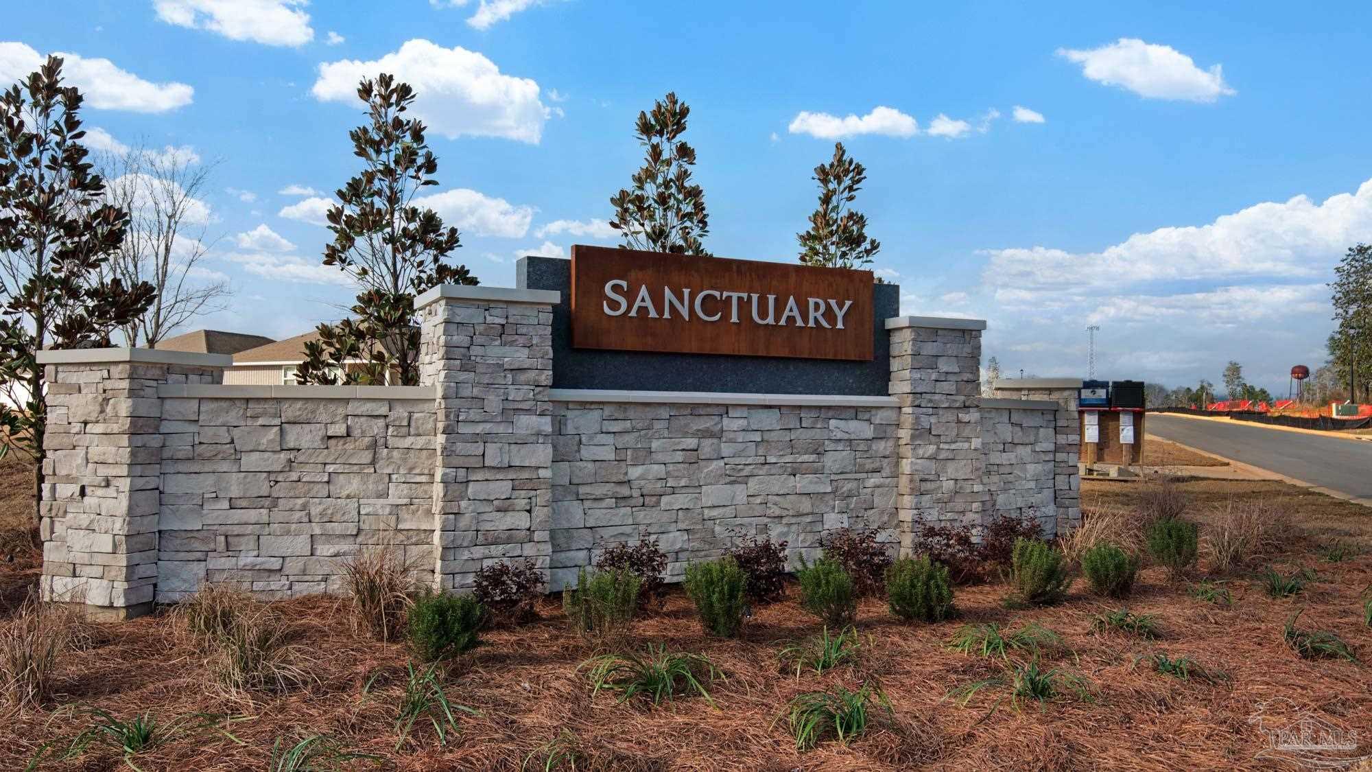 2049 Limpkin Street Cantonment, FL 32533 - Photo 5 of 33 a view of a brick wall with a building in the background