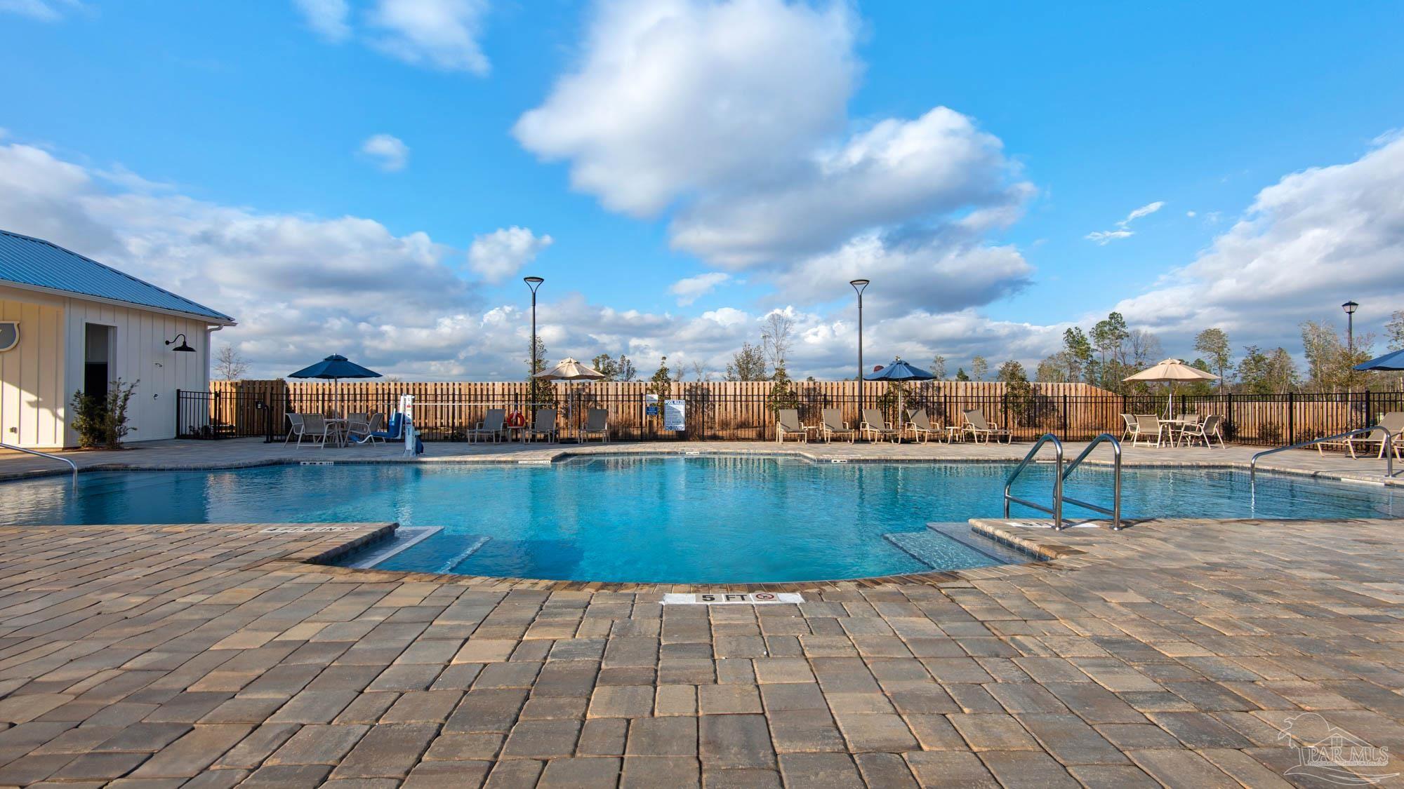 2049 Limpkin Street Cantonment, FL 32533 - Photo 6 of 33 a view of a swimming pool with a lounge chairs