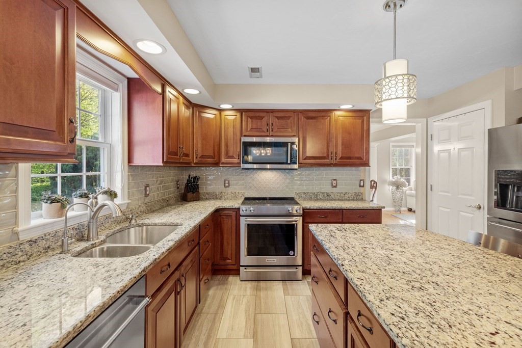 17 Amherst Road Shrewsbury, MA 01545 - Photo 12 of 42 a kitchen with stainless steel appliances granite countertop a sink stove and refrigerator