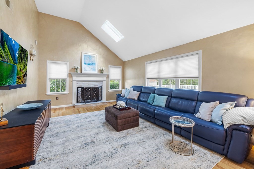 17 Amherst Road Shrewsbury, MA 01545 - Photo 18 of 42 a living room with furniture a flat screen tv and a fireplace