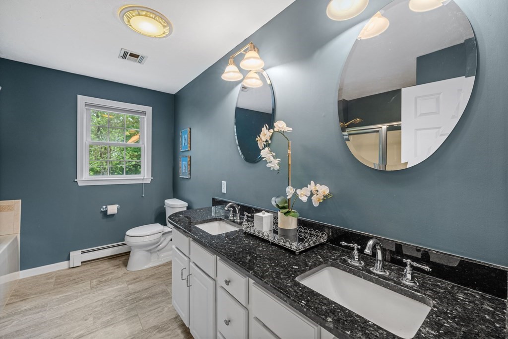 17 Amherst Road Shrewsbury, MA 01545 - Photo 22 of 42 a bathroom with a granite countertop double vanity and a mirror