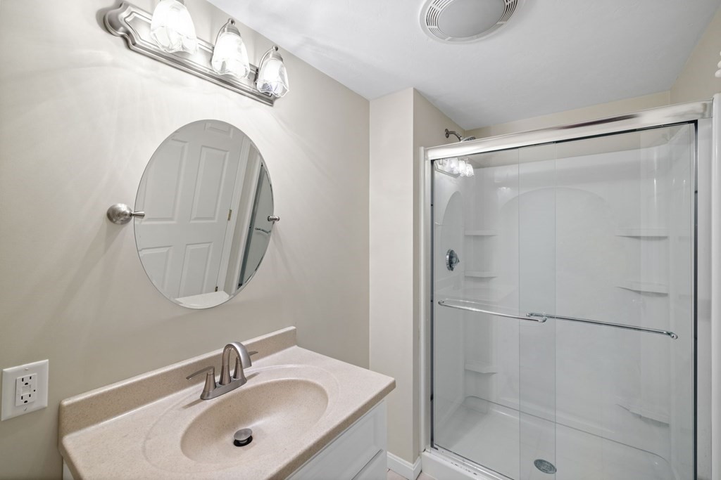 17 Amherst Road Shrewsbury, MA 01545 - Photo 32 of 42 a bathroom with a sink mirror and shower