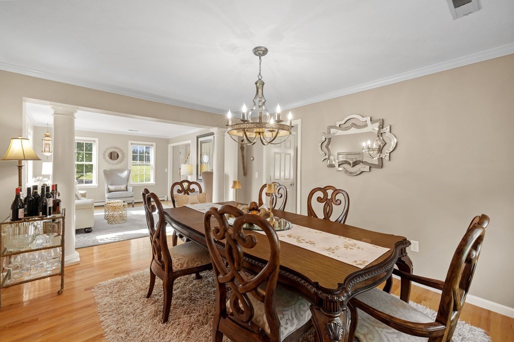 17 Amherst Road Shrewsbury, MA 01545 - Photo 7 of 42 a view of a dining room with furniture a chandelier and wooden floor