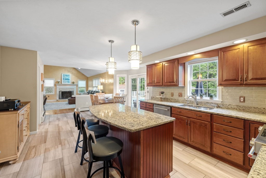 17 Amherst Road Shrewsbury, MA 01545 - Photo 10 of 42 a kitchen with granite countertop wooden floors and wooden cabinets