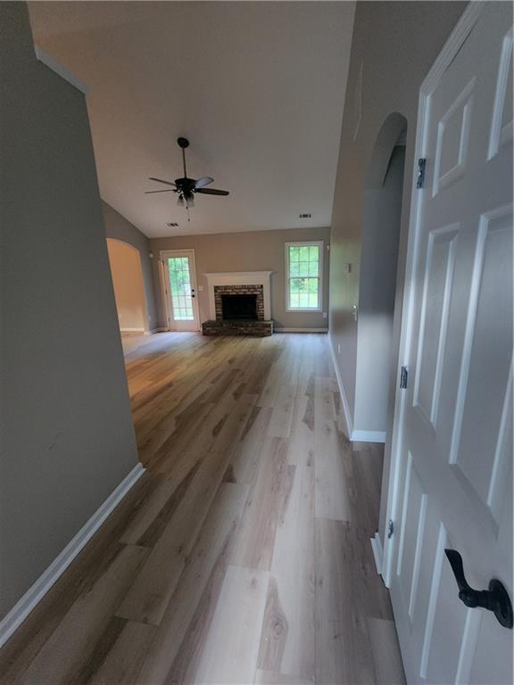 435 Butler Bridge Circle Covington, GA 30016 - Photo 3 of 25 wooden floor in an empty room with a fireplace