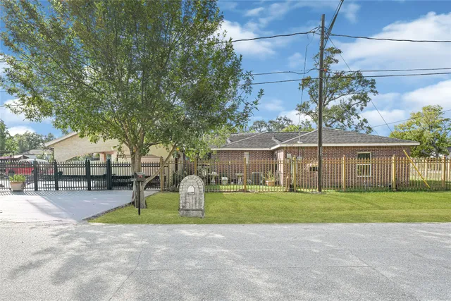 a front view of a house with a yard and trees