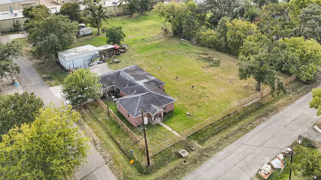 an aerial view of a house with a yard