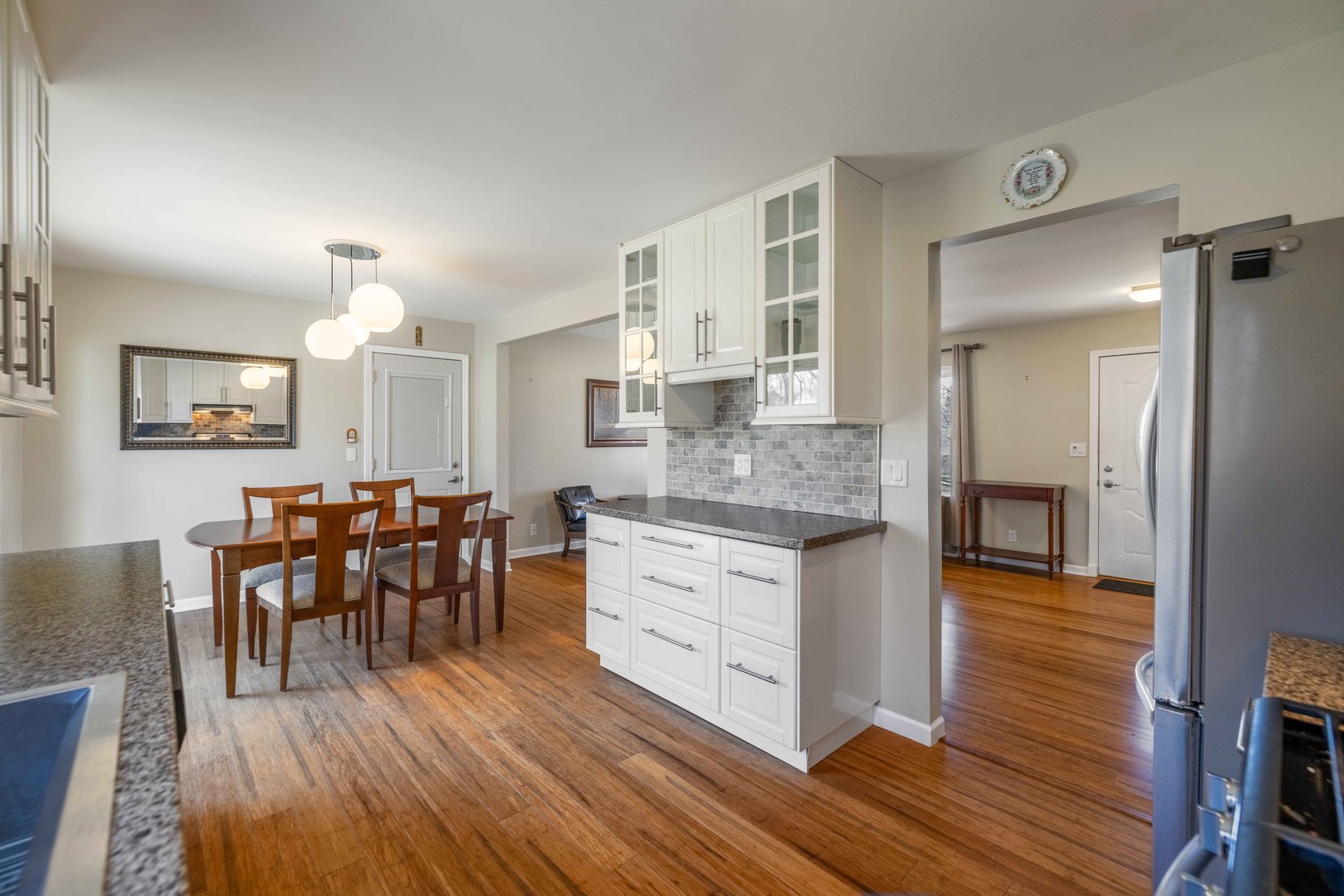 619 Scott Street Algonquin, IL 60102 - Photo 17 of 48 a view of a dining room and livingroom with furniture wooden floor a chandelier