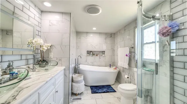 a bathroom with a sink a toilet and shower curtain