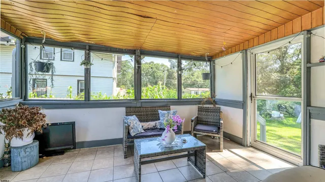 a living room with furniture and a floor to ceiling window