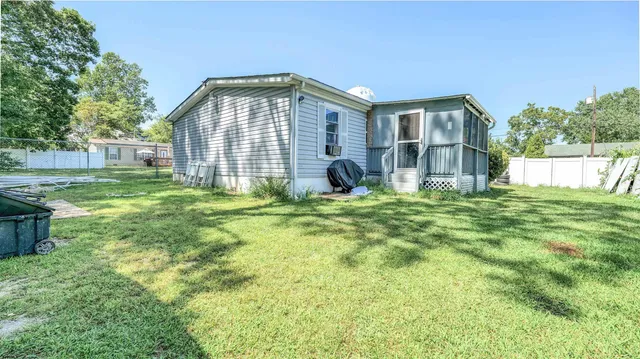 a front view of house with yard and outdoor seating