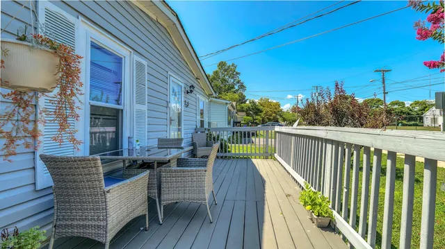 a view of balcony with wooden floor and outdoor seating