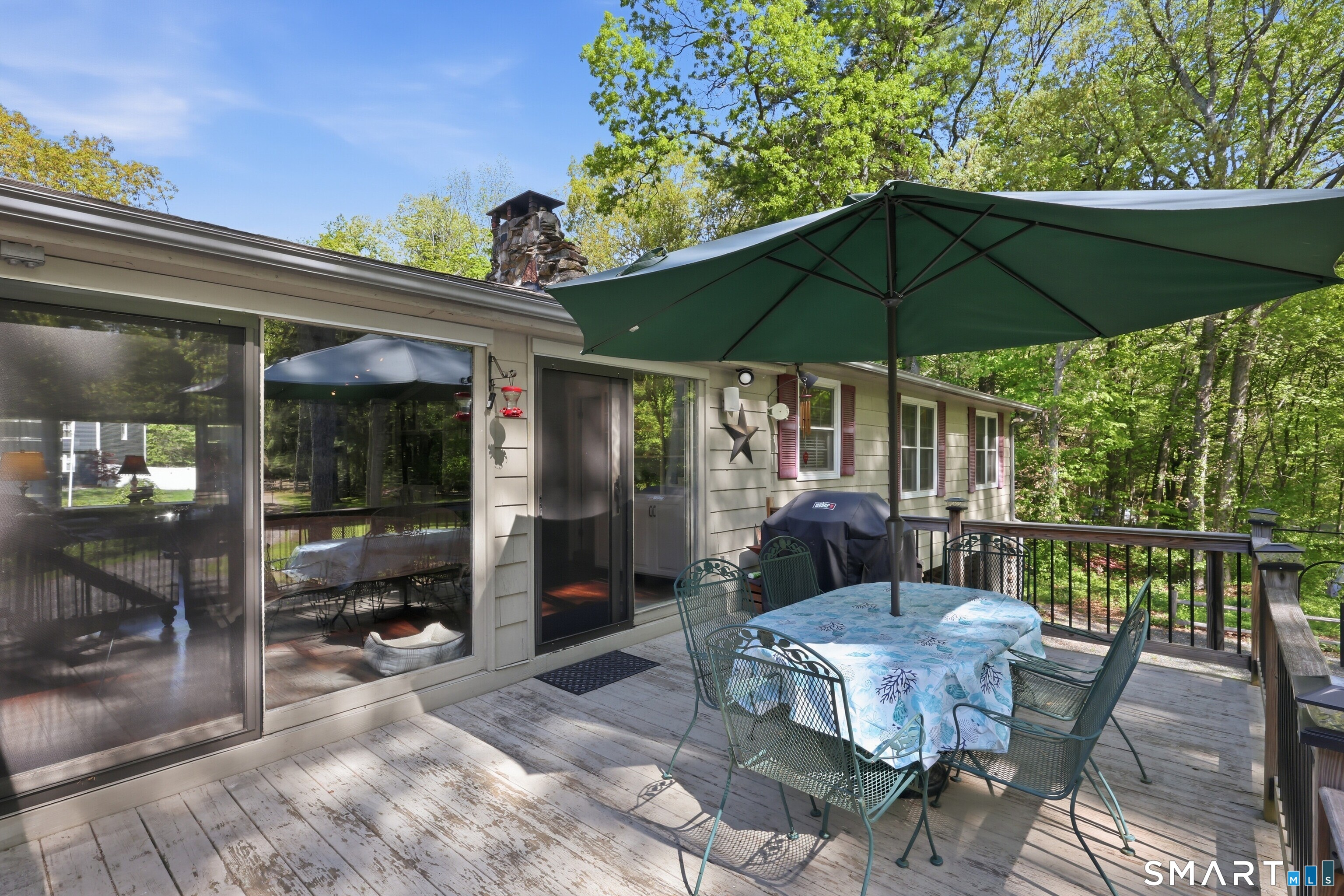 174 Canton Road Granby, CT 06035 - Photo 21 of 35 a view of a patio with a table chairs and a umbrella