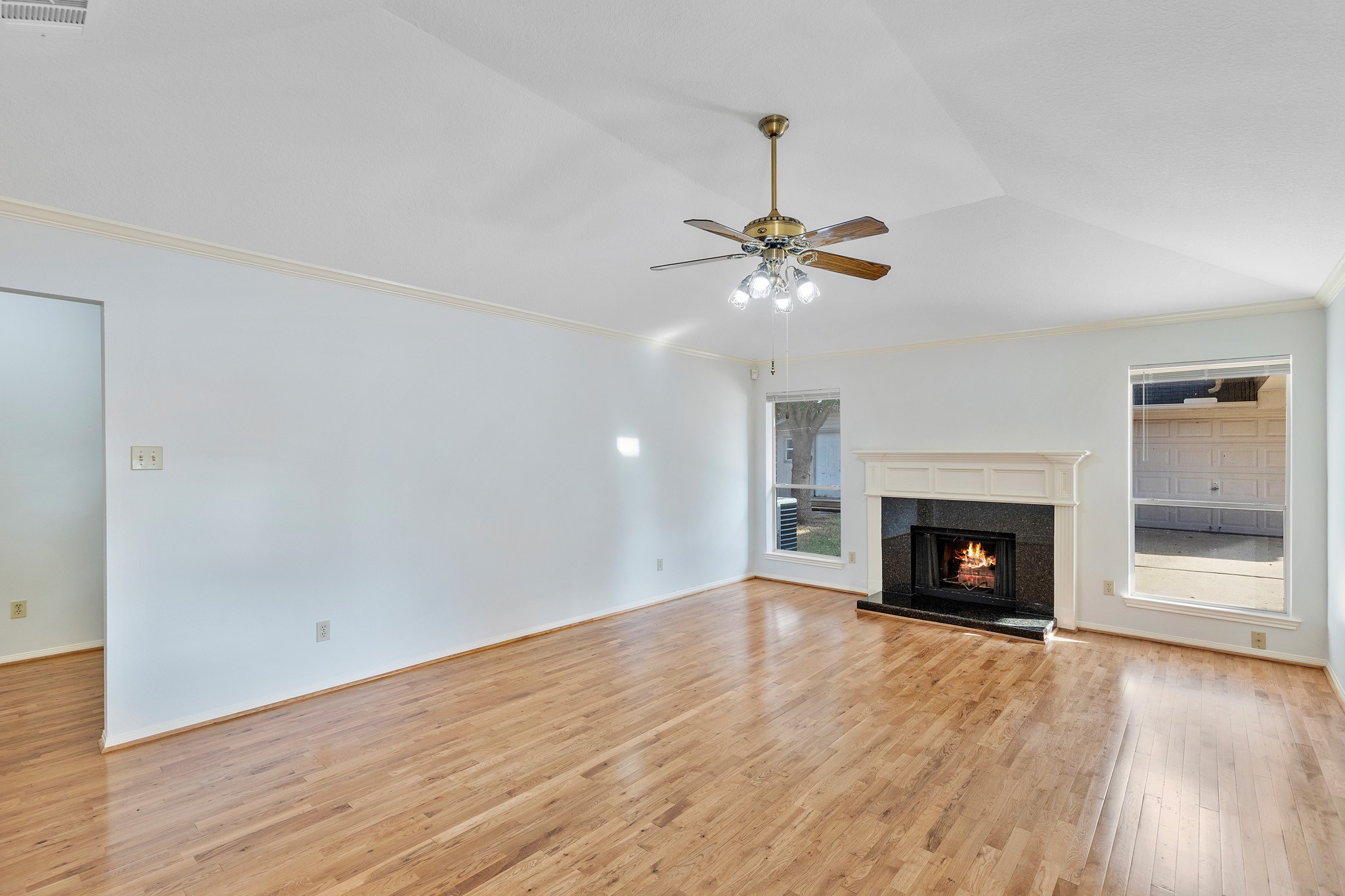 8018 Holiday Lane Houston, TX 77075 - Photo 11 of 42 a view of an empty room with wooden floor fireplace and a window