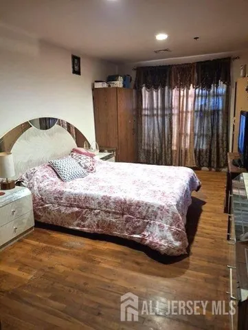 a bedroom with a bed and large mirror