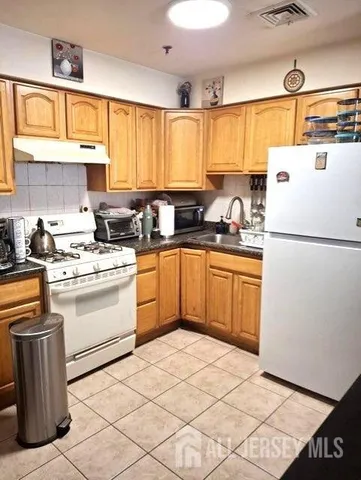 a kitchen with a sink cabinets and window
