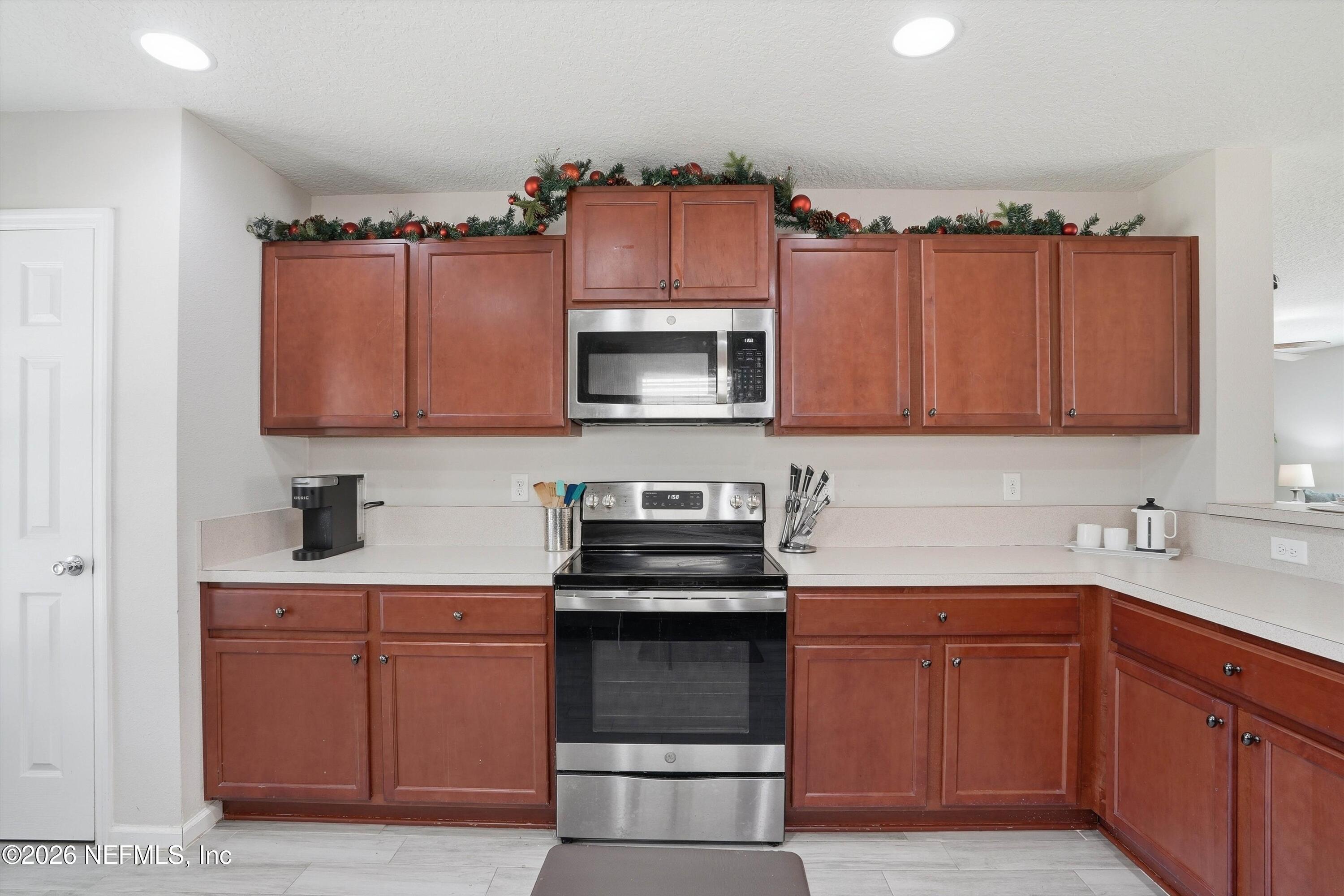 29 Auburn Oaks Road West Jacksonville, FL 32218 - Photo 11 of 38 a kitchen with stainless steel appliances a stove a sink and a microwave