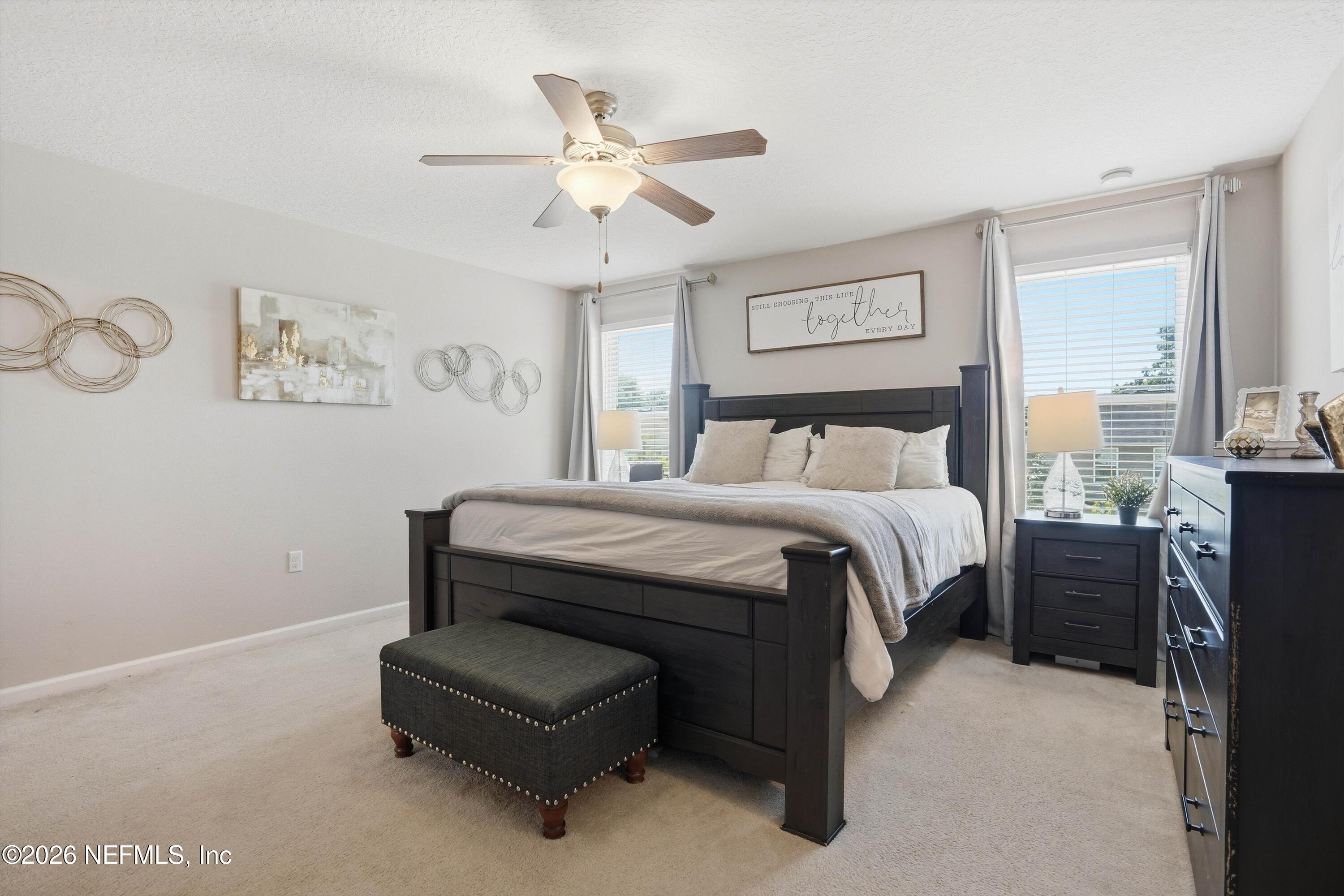 29 Auburn Oaks Road West Jacksonville, FL 32218 - Photo 13 of 38 a bedroom with a bed and a chandelier