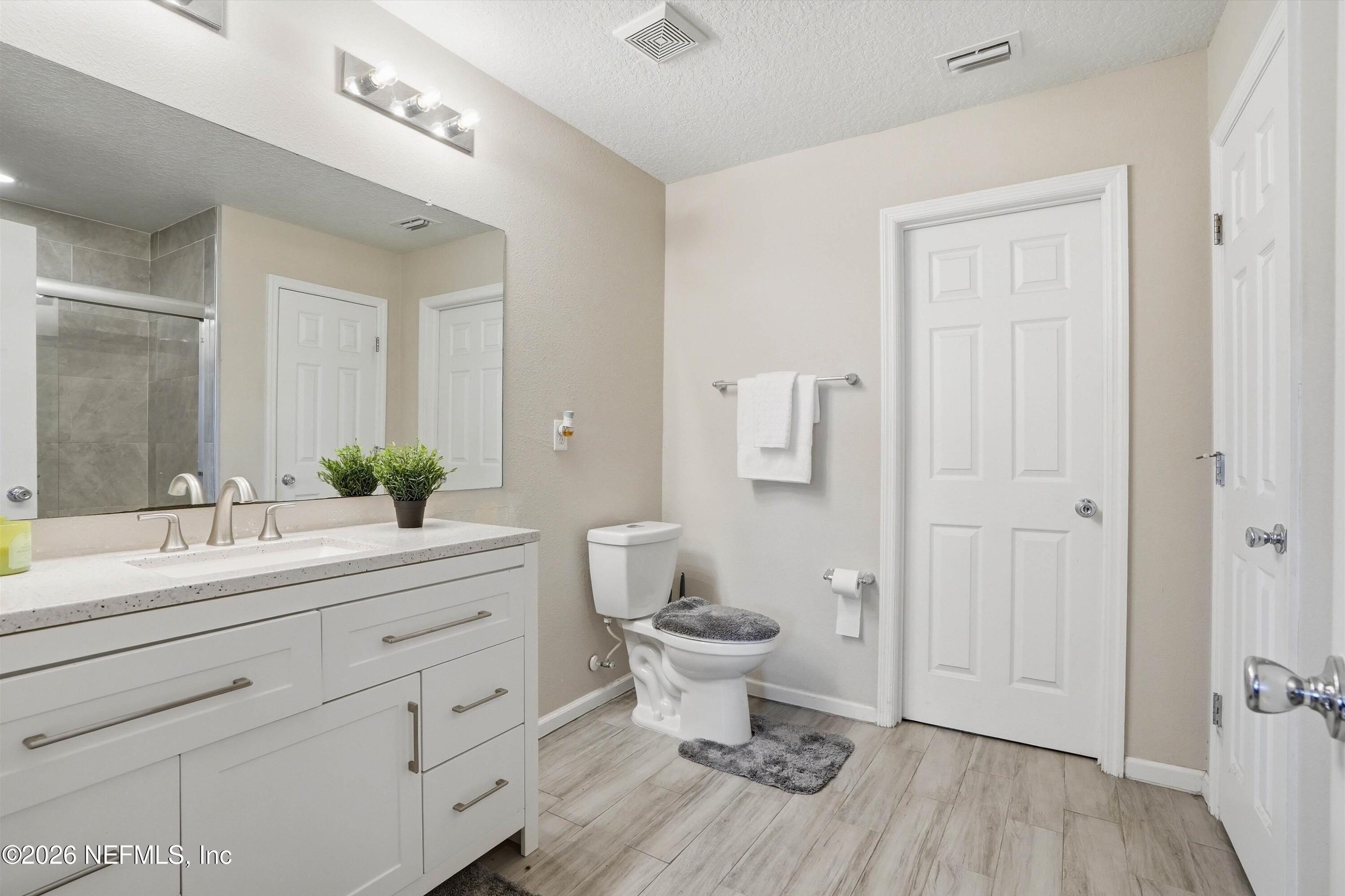 29 Auburn Oaks Road West Jacksonville, FL 32218 - Photo 15 of 38 a bathroom with a double vanity sink toilet and shower