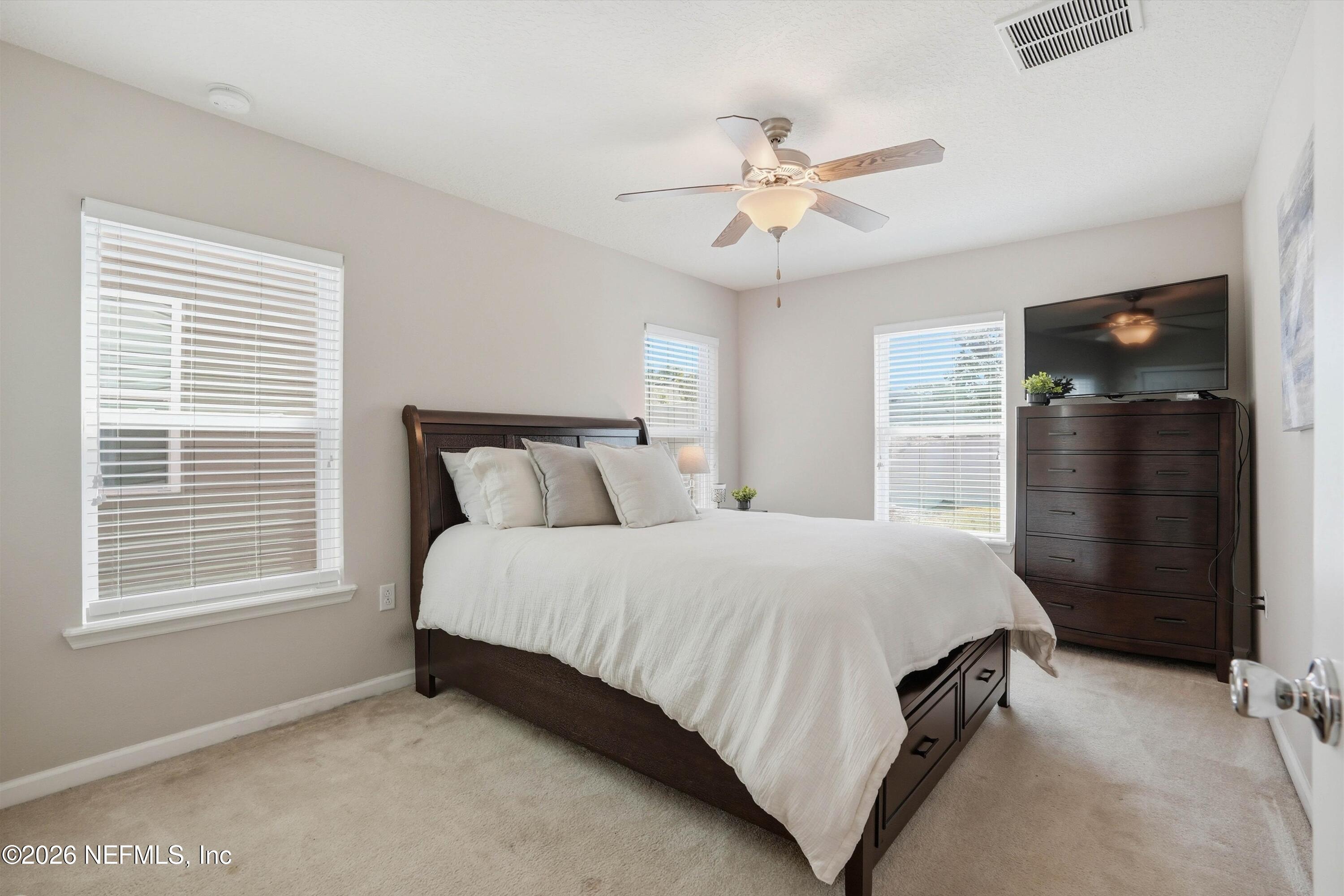 29 Auburn Oaks Road West Jacksonville, FL 32218 - Photo 17 of 38 a bedroom with a bed and window