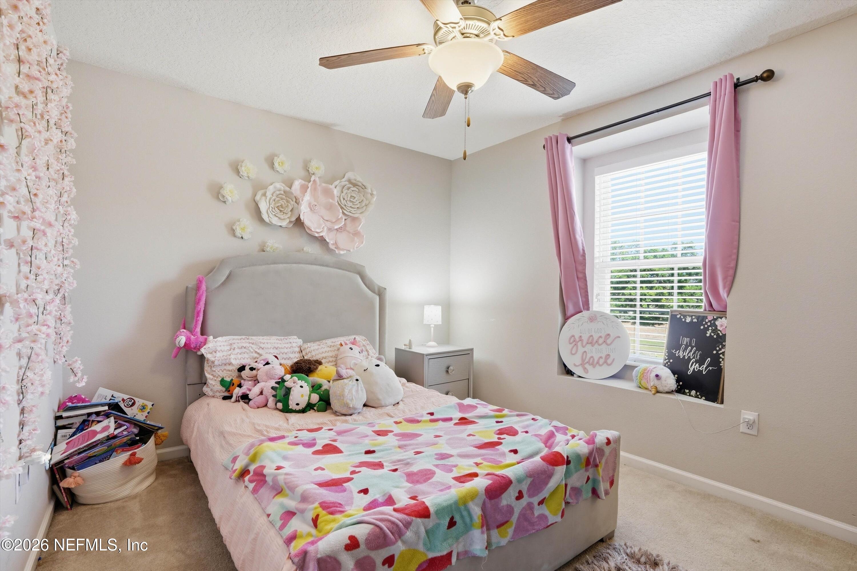 29 Auburn Oaks Road West Jacksonville, FL 32218 - Photo 22 of 38 a bedroom with a bed and a chandelier
