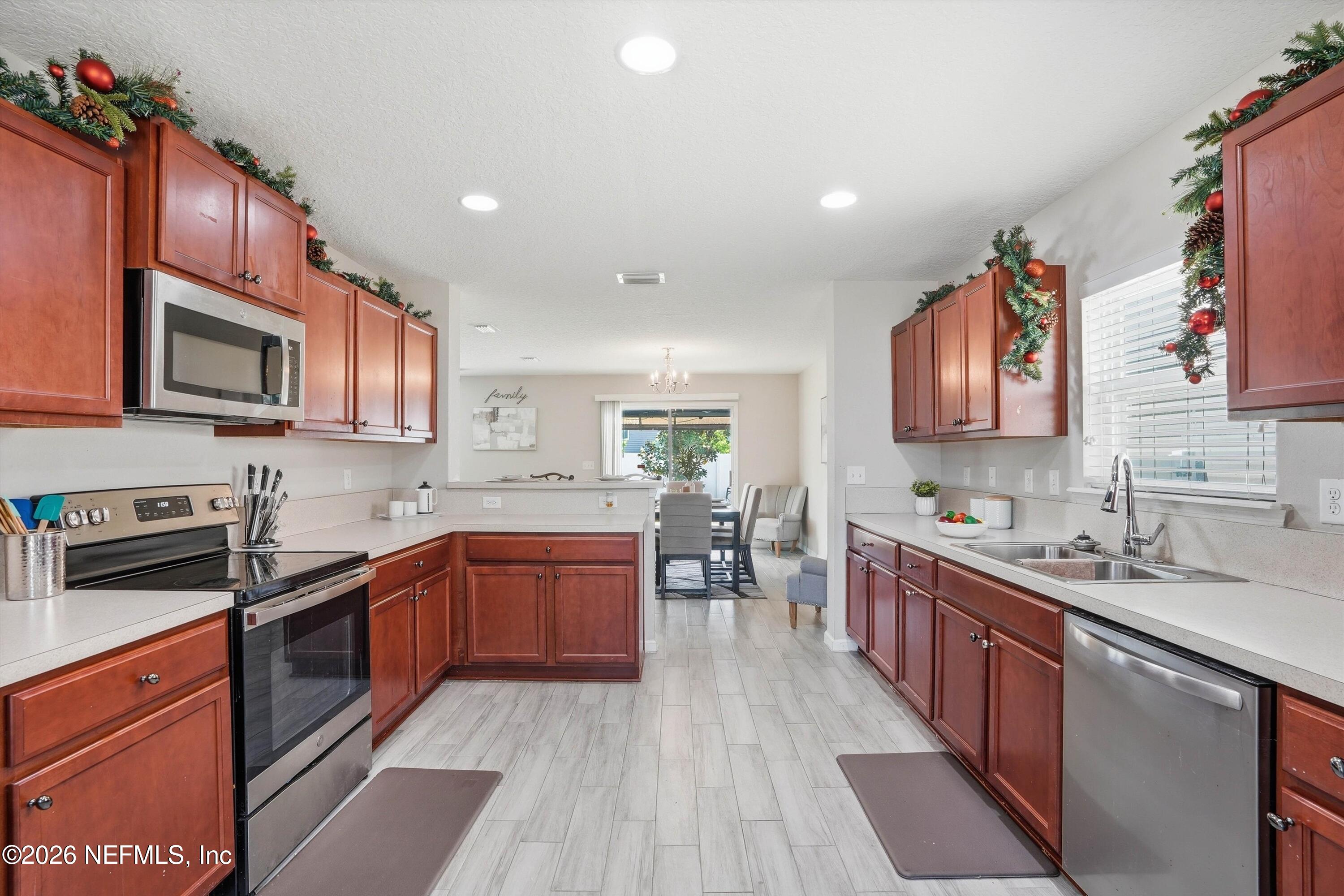 29 Auburn Oaks Road West Jacksonville, FL 32218 - Photo 8 of 38 a kitchen with stainless steel appliances granite countertop wooden cabinets a stove top oven a sink and dishwasher