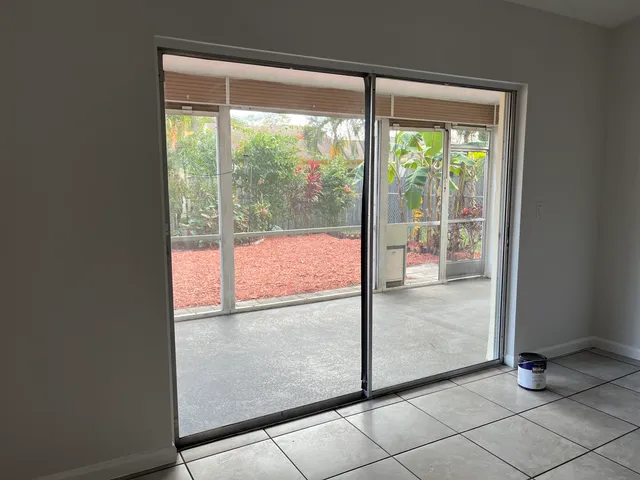 a view of a tree in front of a white house