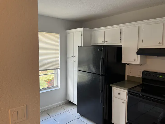 a kitchen with a refrigerator a stove a microwave and cabinets